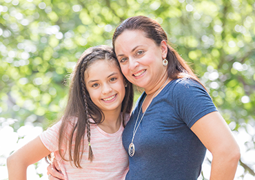 Mother smiling with her daughter who has InBrace orthodontics