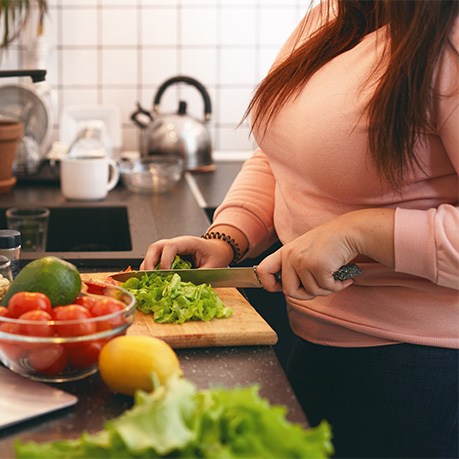 Woman preparing healthy meal in kitchen at home