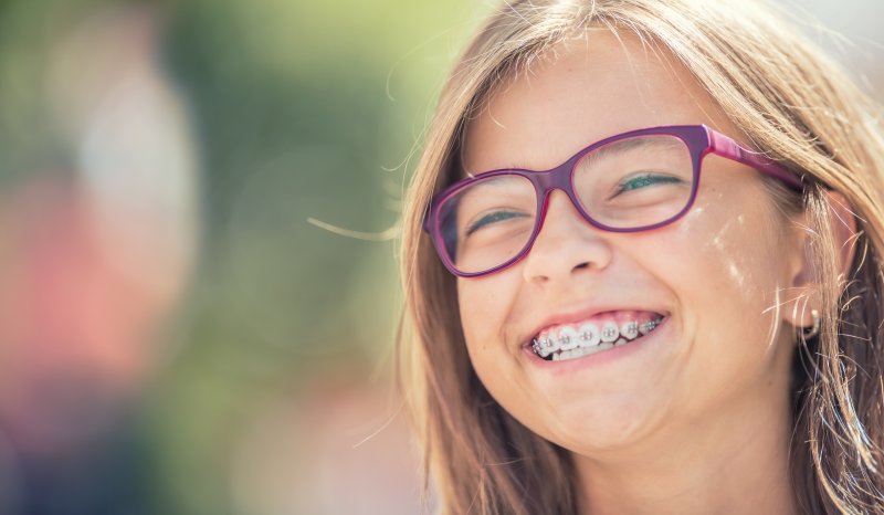 Girl smiles with braces