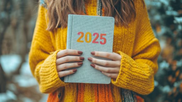 A woman holding a 2025 planner