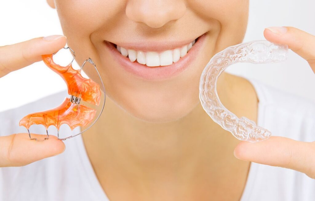 A woman holding two retainers